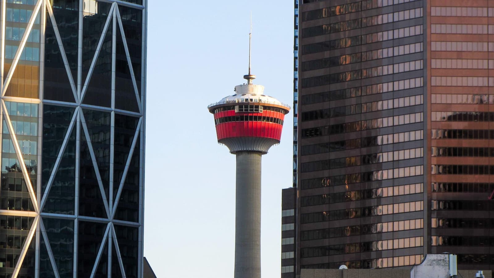 Calgary Tower framed between downtown buildings